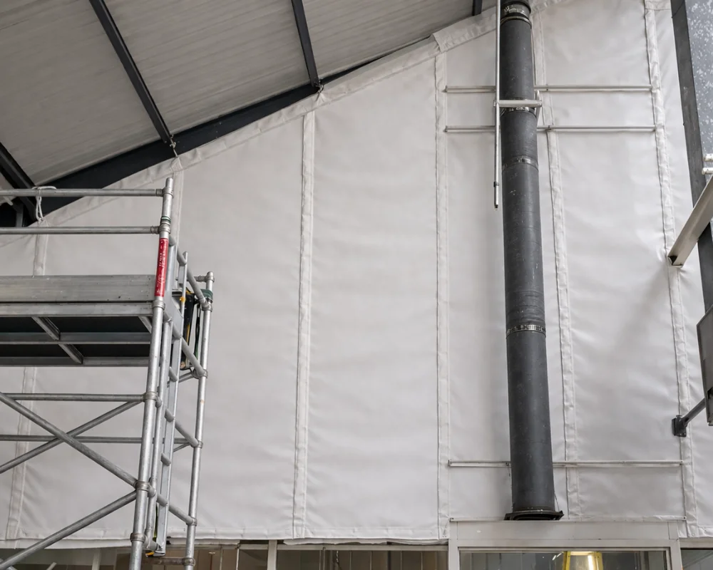 Fire curtain system installed in an industrial building to create a fire-resistant barrier and prevent smoke and fire spread